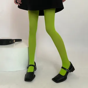 Vibrant green velvet tights detail view, soft 80D hosiery for stylish daily autumn outfits.