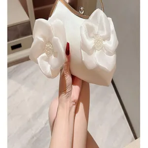 Elegant white satin evening clutch bag with pearl flower details for women wedding party dresses.