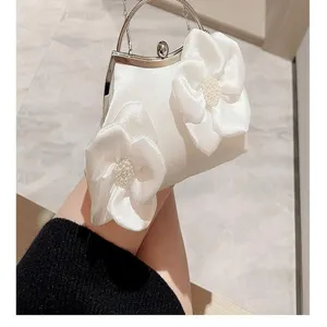 Elegant white satin evening clutch bag with large fabric floral design and pearls for women.