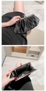 Elegant black satin evening clutch bag with rhinestone metal frame and chain for formal events.
