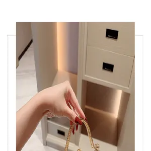 Elegant evening bag detail featuring a luxurious metal handle, perfect for formal party dresses.