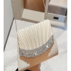 Elegant pleated velvet evening clutch bag with sparkling rhinestone detail and chain strap.