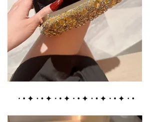 Close-up of luxury rhinestone evening clutch bag with sparkling crystals and metal frame details.