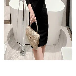 Detail view of a glamorous sparkly evening handbag with metal handle for luxury party events.