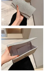 Silver glitter evening clutch bag detail showcasing interior chain and pocket structure