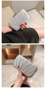 Silver pleated evening clutch bag for women, elegant handbag with metal clasp for party dress.