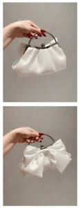 Witte satijnen avondtas clutch met metalen ringhandgreep en striK ontwerp voor bruiloften.