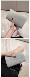 Silver glitter clutch bag for women, elegant evening party purse with pleated design and chain.