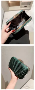 Close-up detail of a dark green pleated evening clutch bag with metallic frame and chain.