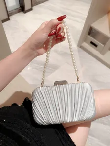 Elegant silver pleated evening clutch bag with pearl handle for party and wedding dress.