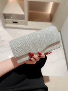 Elegant silver glitter pleated evening clutch bag for women, perfect for weddings and parties.