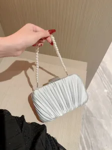 Elegant silver pleated evening clutch bag with pearl handle for party and wedding events.