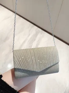 Fashion women's pleated clutch evening bag with chain strap, elegant metallic design for parties.
