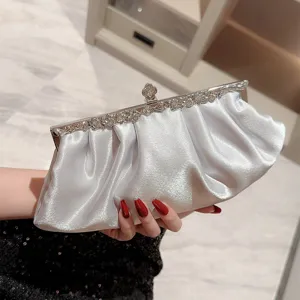 Silver satin evening clutch bag with pleated design and rhinestone metal frame for formal party.