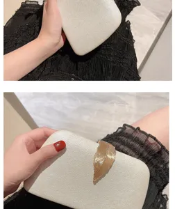 Elegant women's evening clutch bag with a stunning gold leaf clasp, perfect for parties.