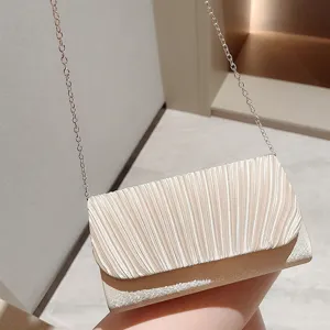 Pleated evening shoulder bag for women, elegant white crossbody bag with chain strap.