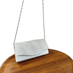 Silver glitter evening clutch bag with chain strap for party, wedding and formal dress events.