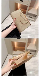 Detailed view of the elegant gold pleated evening clutch with metal frame and handle.