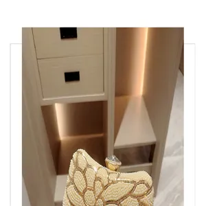 Exquisite pearl beaded evening clutch bag with sparkling rhinestones and crystal clasp detail.