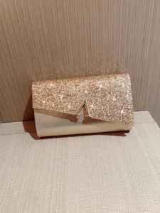Sparkling gold evening clutch bag, elegant glitter wedding party purse with metal clasp.
