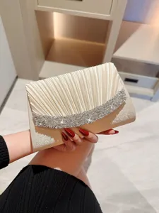 Elegant champagne pleated evening clutch bag with sparkling rhinestone flap for parties.