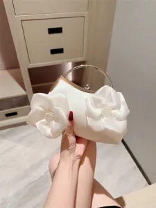 Elegant white satin evening clutch bag with floral design, perfect for weddings and parties.
