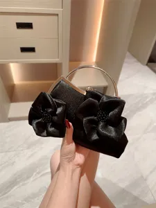 Elegant black satin evening clutch bag with metal handle and stunning 3d flower decoration.