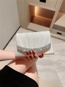 Elegant white pleated evening clutch with sparkling rhinestones, perfect for formal dresses.