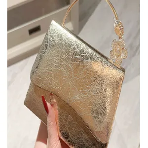 Gold metallic leather evening clutch bag with rhinestone flower metal ring handle for women party.