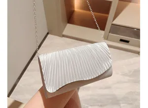 Detailed shot of the elegant pleated satin evening clutch bag with a chic metallic chain strap.