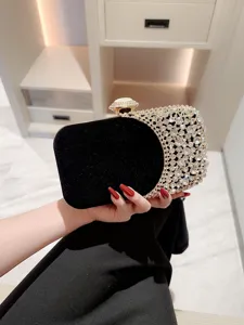Elegant black velvet evening clutch bag featuring sparkling crystal mesh and gold clasp.