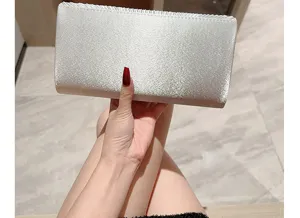 Silver satin evening clutch bag with pleated flap design, elegant formal party purse.
