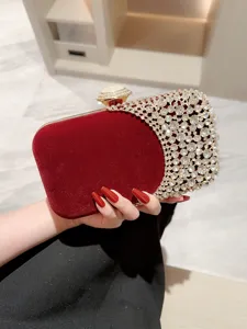 Red velvet evening clutch bag with sparkling crystal rhinestones and elegant gold clasp for women.