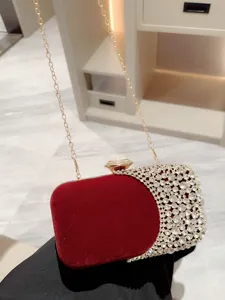 Elegant red velvet evening clutch bag with sparkling rhinestones and chain strap for women.