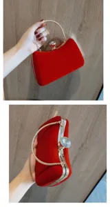 Red velvet evening clutch bag detail showing gold metal frame, chain handle and crystal clasp.