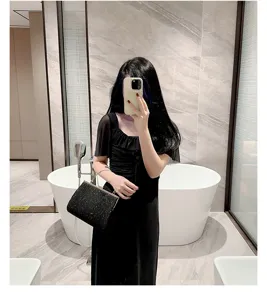 Black sparkling evening handbag with metallic handle, elegant clutch for party and banquet.