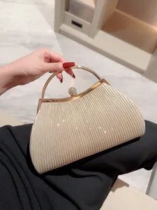 Elegant gold pleated evening clutch bag with metal ring handle and sparkling rhinestone clasp.