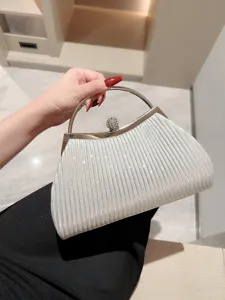 Elegant pleated evening clutch bag with metal round handle and rhinestone clasp for women.