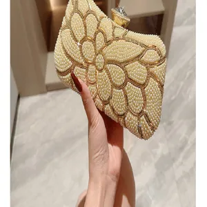 Elegant pearl evening clutch bag with rhinestone clasp and floral design for women parties.