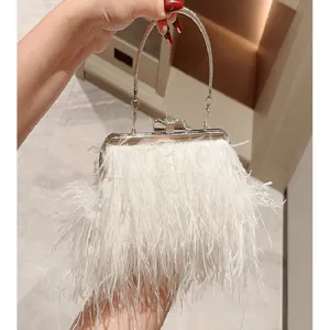 Detailed view of white feather evening bag with rhinestone handle and metal clasp for women.