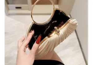 Satin pleated evening clutch bag with metal ring handle, elegant party purse detail.