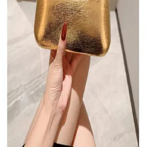 Gold leather evening bag clutch for women, vintage style party dress handbag with elegant texture.