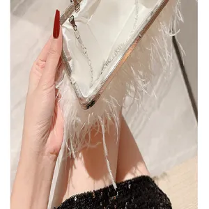 White feather evening bag detail, elegant clutch purse with metal chain and clasp.