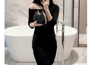 Elegant black satin pleated evening bag with metal ring handle for women party and wedding.