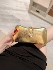 Elegant gold metallic evening clutch bag with sparkling rhinestone teardrop clasp for women