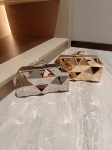 Metallic geometric evening clutch bag, stylish silver and gold polygon structured purse.