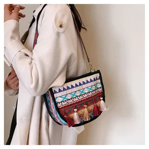 Ethnic style embroidered crossbody bag for women, fashion shoulder bag with colorful tassels.