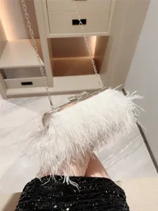 White feather evening clutch bag with silver chain and rhinestone bow for women parties.