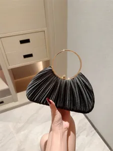 Elegant black satin pleated evening bag with luxury gold round ring handle for women party.