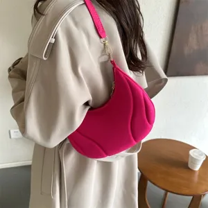 Hot pink hobo shoulder bag for women, trendy crescent underarm bag with chic textured panels.